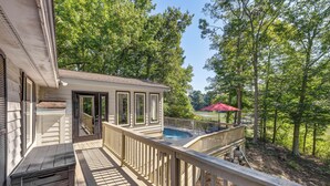 A deck with a pool, surrounded by trees. - Waterfront Urbanna Home w/ Private Dock (Urbanna)