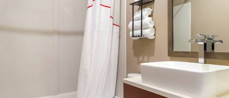A bathroom with a bathtub, toilet, and sink.