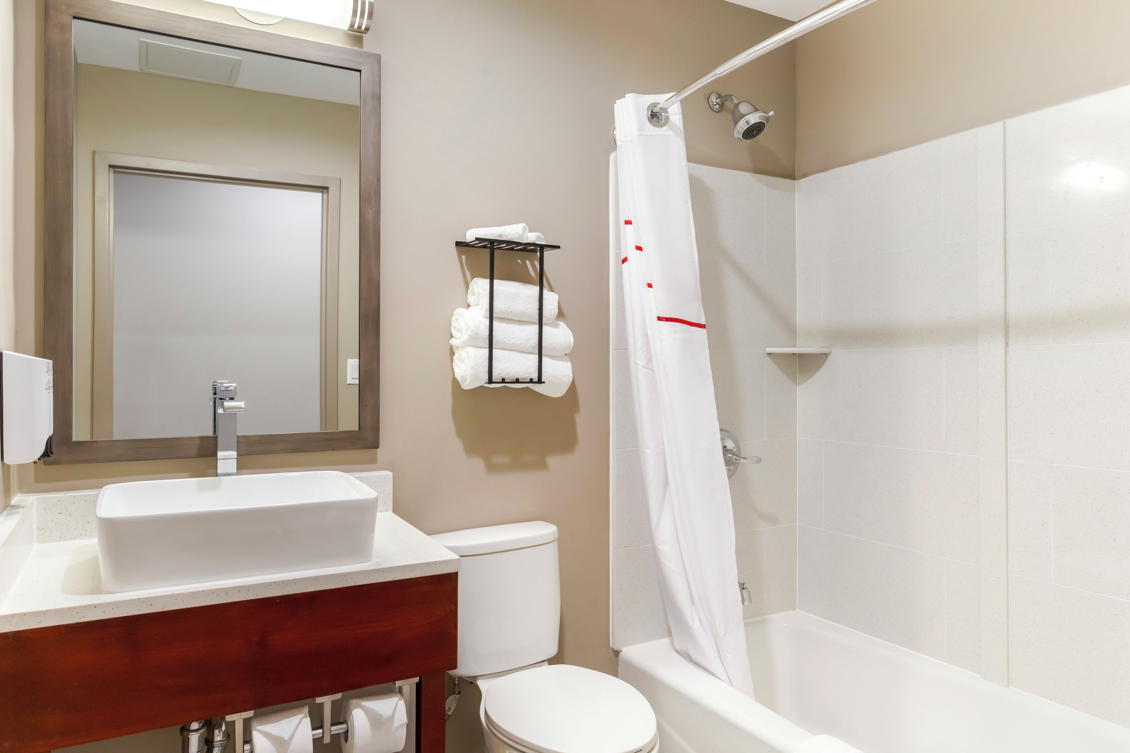 A bathroom with a white sink, toilet, and bathtub.
