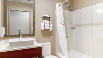 A bathroom with a white sink, toilet, and bathtub.