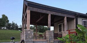 A covered outdoor area with stone pillars, a barbecue grill, and outdoor furniture. - View on the Ridge close to Ark Encounter. (Williamstown)