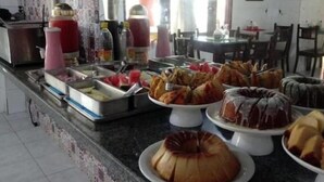 A buffet area with various food items and condiments. - INFINITY POUSADA (Aracaju)