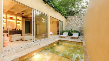 Relax by the pool surrounded by a pebble-lined deck and lounge chairs.