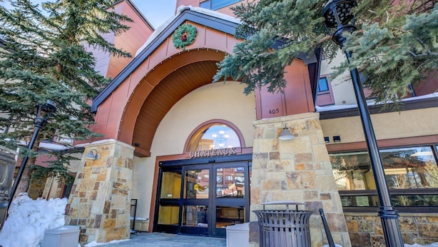 A hotel entrance with a stone facade, a large arched doorway, and a sign reading "CHATEAU". - 2 Bedroom Ski-in, Ski-out Condo at The Village at Peak 9 (Breckenridge)