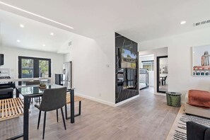 A modern interior with a dining area, kitchen, and living space.