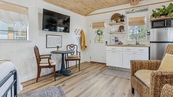 A cozy interior with a dining area, kitchen, and seating space.