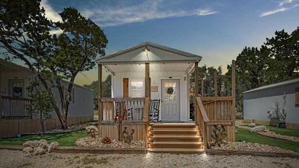A single-story building with a porch, a door with a wreath, and a number '2' sign. - Lucky Star Ranch - Stargazer (Bandera)