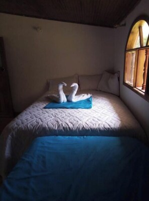 Restful retreat with a large bed, quilted headboard, and plush bedding.