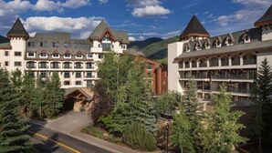 A large, multi-story hotel with a traditional architectural style, featuring a central courtyard and multiple balconies. - Luxury 1 Bedroom at The Hythe in Lionshead Village (Vail)