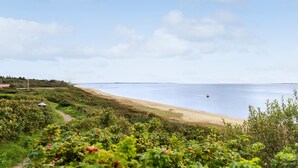 A coastal landscape with a sandy beach, dense greenery, and a clear sky. - 2 bedroom cozy home in Esbjerg V (Esbjerg V)