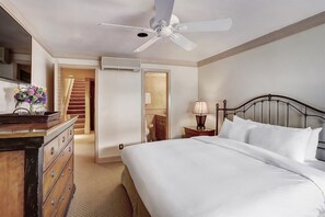 A hotel room with a bed, dresser, nightstand, lamp, and a ceiling fan. - 4 Bedroom Luxury Residence at World-class Resort in Lionshead Village (Vail)