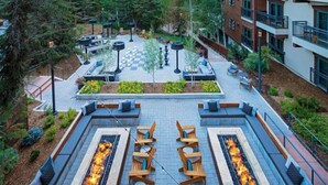An outdoor courtyard with fire pits, seating areas, and a chessboard. - 4 Bedroom Luxury Residence at World-class Resort in Lionshead Village (Vail)
