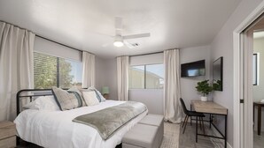 A bedroom with a bed, bedside tables, a desk, a chair, a TV, and a ceiling fan. - Wine Country Escape*Hot Tub*Fire Pit (Paso Robles)