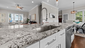 A modern kitchen with a granite countertop, stainless steel sink, and pendant lighting. - Traditional 4BR Craftsman, In DT Durham, Near Duke (Durham)