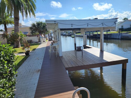 Intercostal channel house with boat dock and ping-pong table 