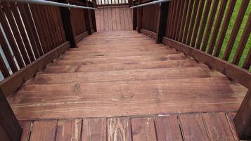 A wooden staircase leading to a higher level, surrounded by a metal railing.