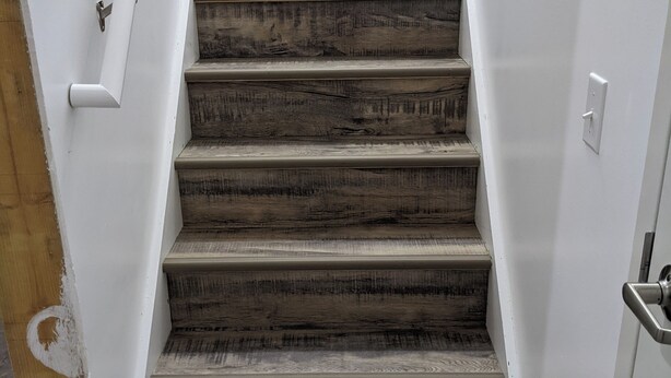 A staircase with wooden steps and white walls. - Cozy 2-bedroom corporate apartment minutes from Lake Cumberland Kentucky.   (Albany)