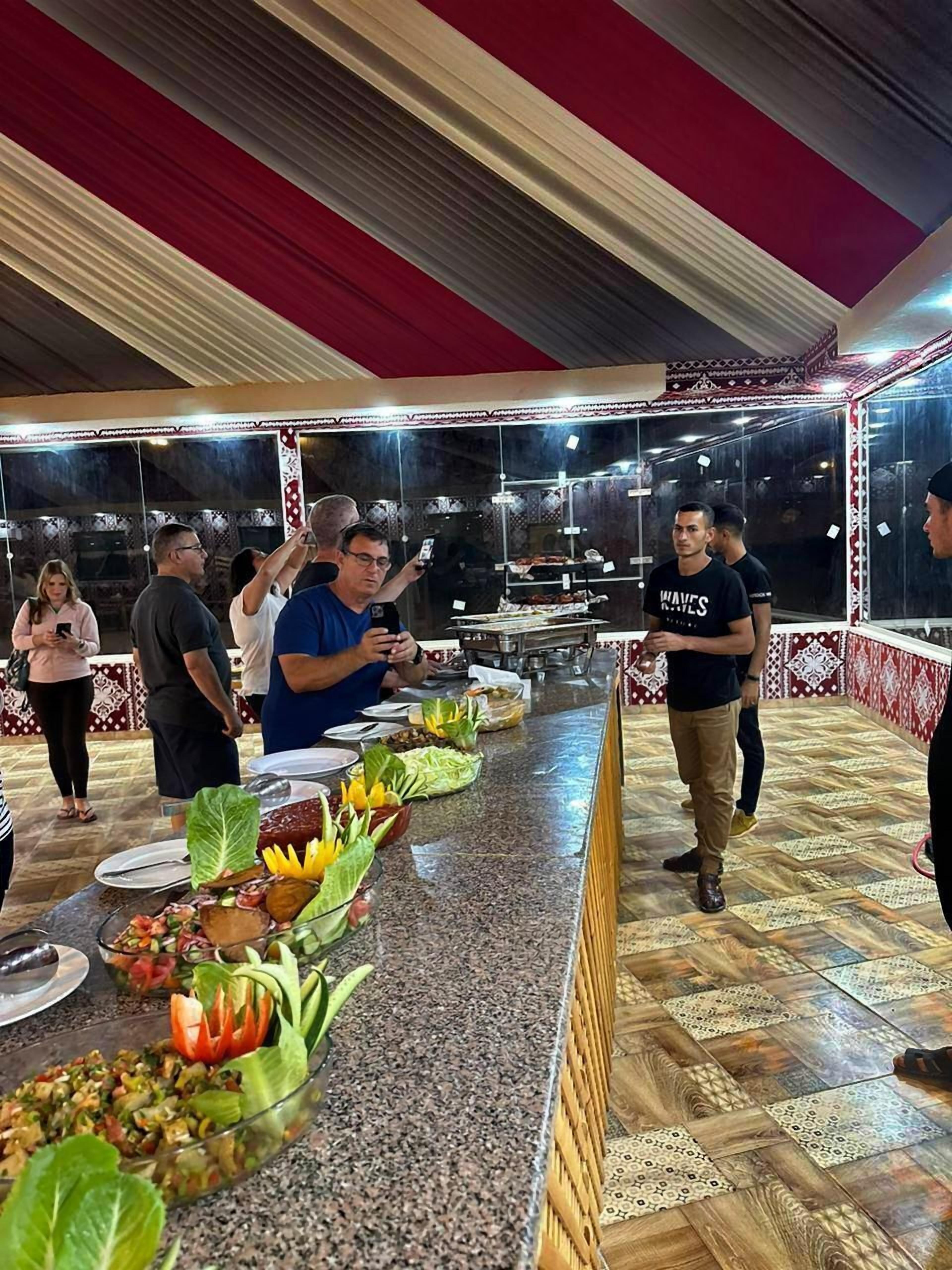 A buffet setup with various food items and a long counter.