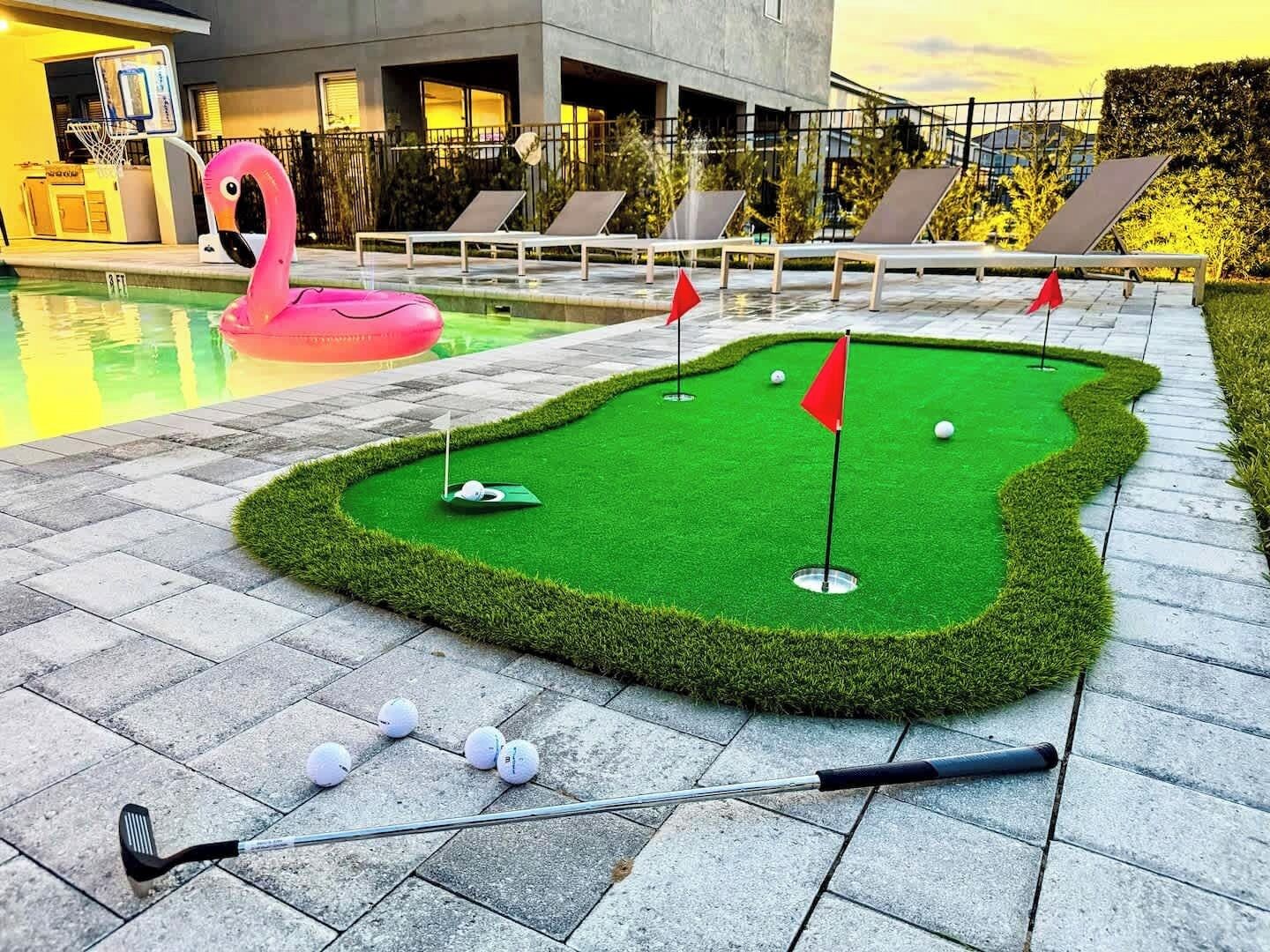 Minigolfrata, jossa on lyöntialue, golfpalloja ja golfmaila.