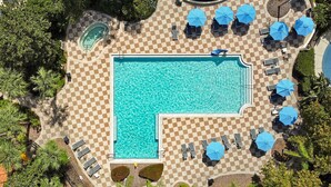 An aerial view of a pool area with checkered flooring, lounge chairs, and umbrellas. - Encantada Resort: Pool, Gym, Clubhouse, 10min to Disney (Kissimmee)