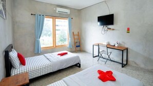 A room with two beds, a desk, a TV, and an air conditioning unit. - Formerly Reddoorz Syariah Lombok Epicentrum Mall (Mataram)