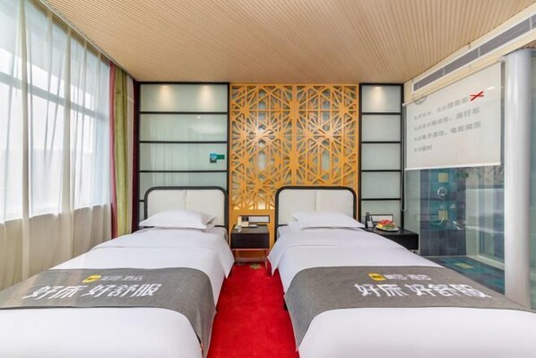 A hotel room with two beds, a red carpet, a decorative wall, and a window with curtains. - AutobotsOutbots Hotel (Aquarium Station) (Zhengzhou)