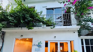 A two-story building with a sign reading "Ramnu Villa". - Ramzu Villa (Thoddoo)