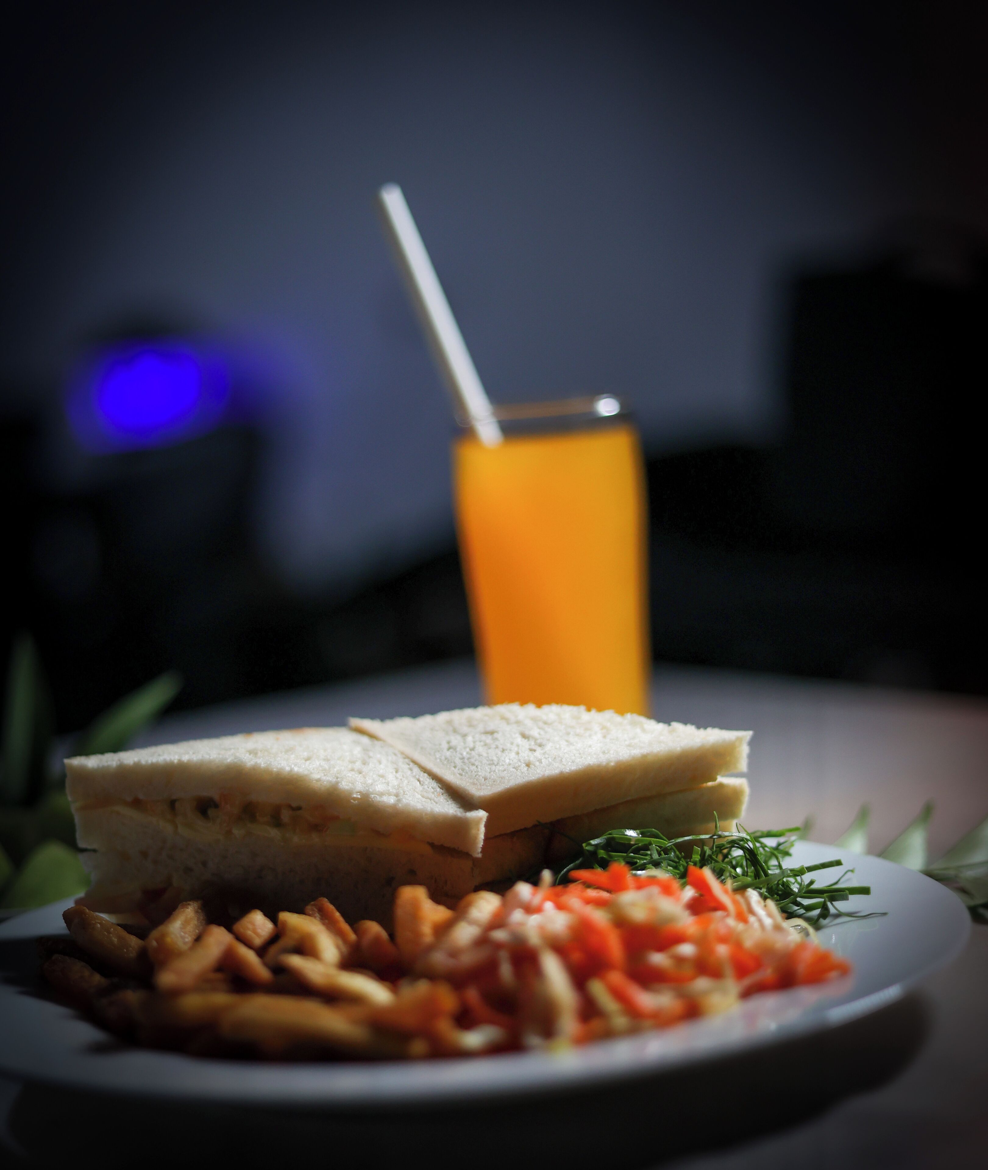 A plate with a sandwich, fries, and a drink.