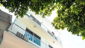 A two-story building with a balcony, a bicycle parked in front, and a sign that reads "Ramala Villas". - Ramzu Villa (Thoddoo)