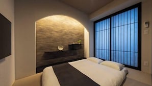 A modern bedroom with a large bed, a built-in bench, and a large window with a view. - Shirakabanoyado - Ebisu (Osaka)