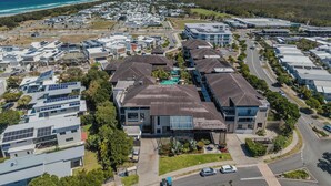 Un quartier résidentiel avec des maisons modernes, une piscine et une route.