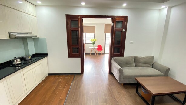 A compact living space with a kitchenette, a sofa, and a dining area.