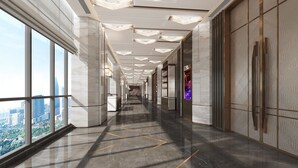 A modern, well-lit corridor with large windows, a polished floor, and a city view. - Four Points by Sheraton Changzhou Economic Development Zone (Changzhou)