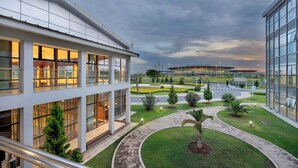 A modern building with large windows and a landscaped courtyard.