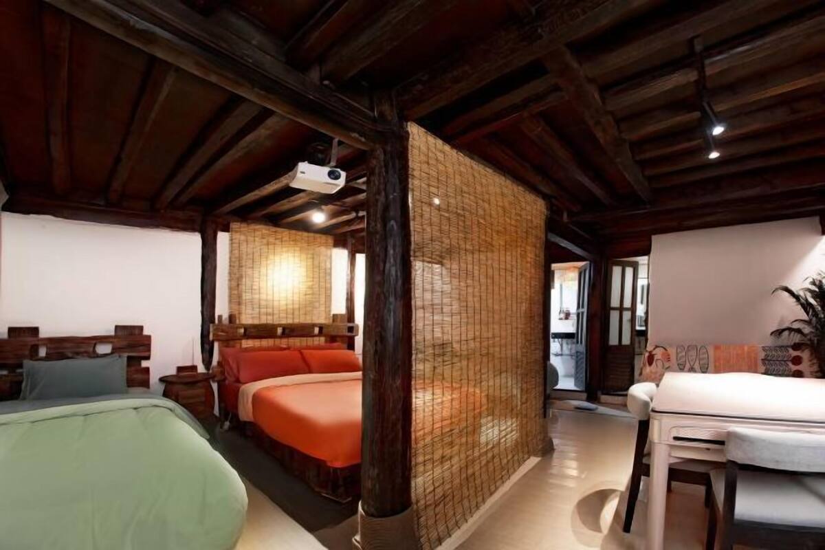 A room with a bed, a desk, and a chair.