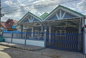 A building with a blue gate and a tiled entrance.