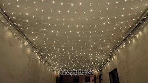 A corridor with string lights hanging from the ceiling. - Tianzishan Inn (Zhangjiajie)