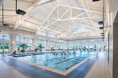 Bayside Resort home with sunroom plus pools, gym, hot tub, & sports courts