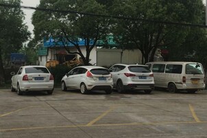 Un estacionamiento con varios coches y una camioneta blanca.