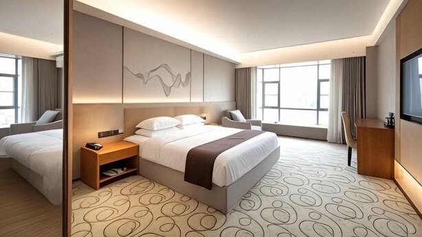 A modern hotel room with a large bed, bedside tables, a desk, and a TV. - Holiday Villas Airport (Guangzhou Baiyun International Airport) (Guangzhou)