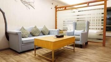 A modern living room with a sofa, armchair, and coffee table.