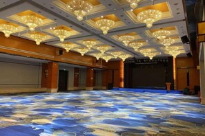 A large hall with a patterned floor, chandeliers, and a stage. - Holiday Villas Airport (Guangzhou Baiyun International Airport) (Guangzhou)