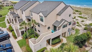 A multi-story residential building with a balcony, a driveway, and a view of the beach. - Seashell Dunes - Oceanfront, Beach Access, Pool (Fernandina Beach)