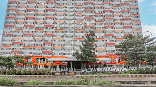 Un grand hôtel dont la façade est caractérisée par une succession de balcons et de fenêtres.