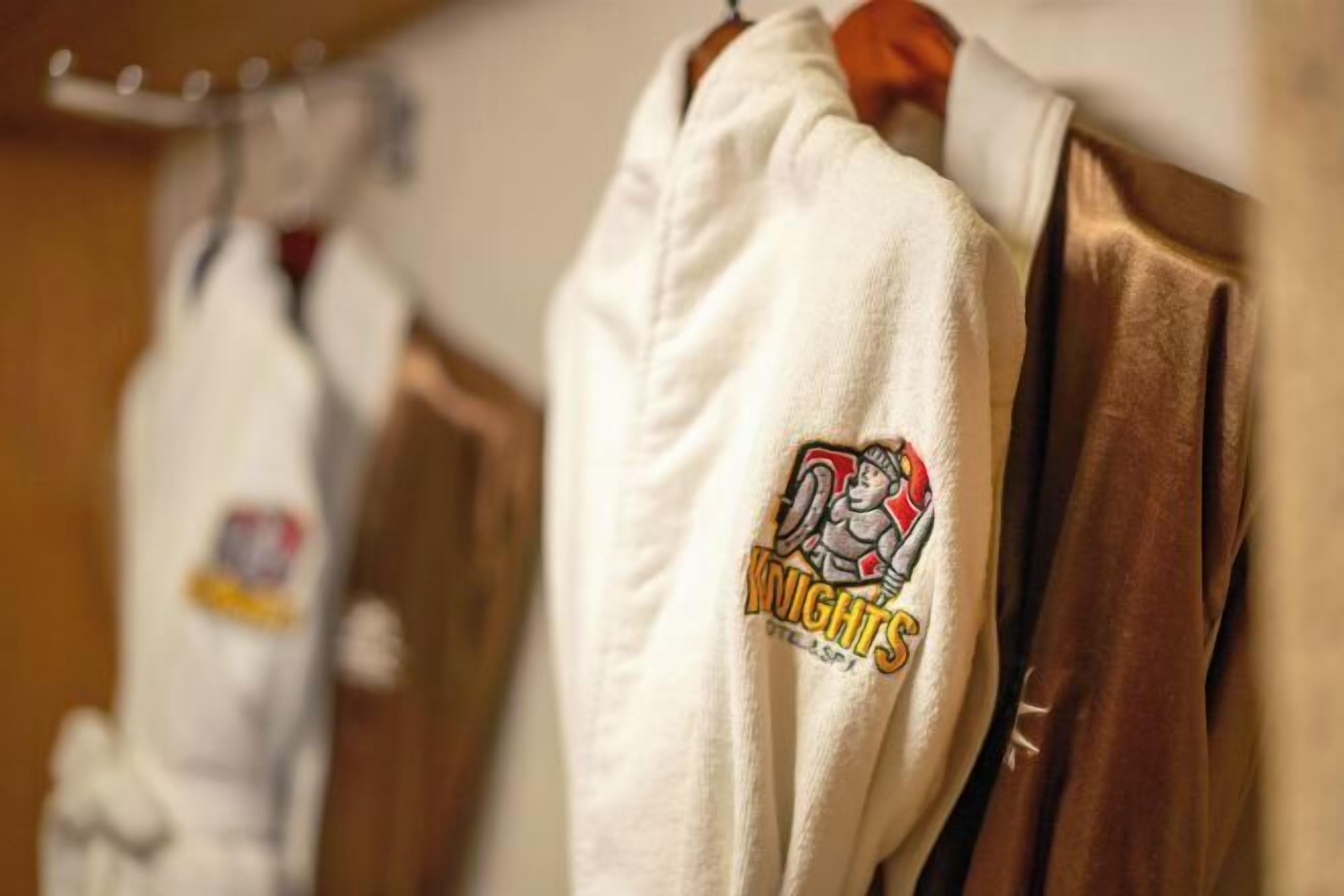 A robe with a logo on the sleeve.