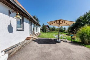 A house with a patio, outdoor furniture, and a satellite dish. - Holiday Apartment Auf Dem Wald 6 Pers. with Mountain View, Private Terrace, and Wi-Fi (Görwihl)