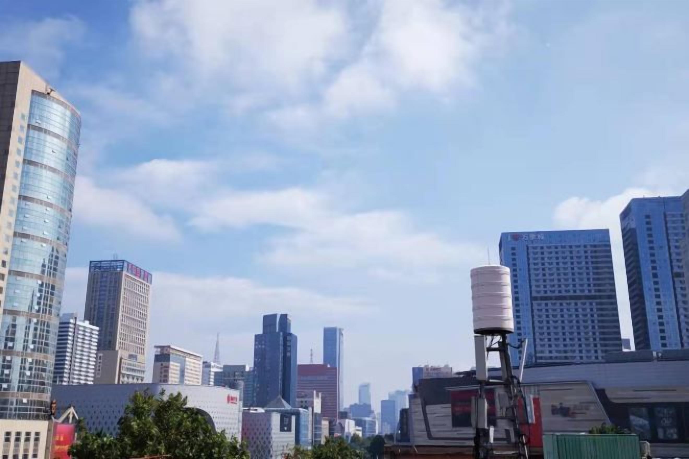 A cityscape with high-rise buildings and a clear sky.