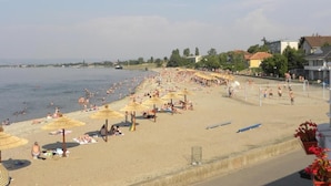 A beach with umbrellas and people.