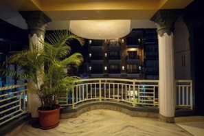 A hotel atrium with a marble floor, a potted palm tree, and a balcony railing. - Trekkers Inn Boutique Hotel Pokhara (Pokhara)