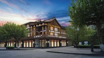 A hotel with a traditional architectural style, multiple floors, and a spacious entrance area.